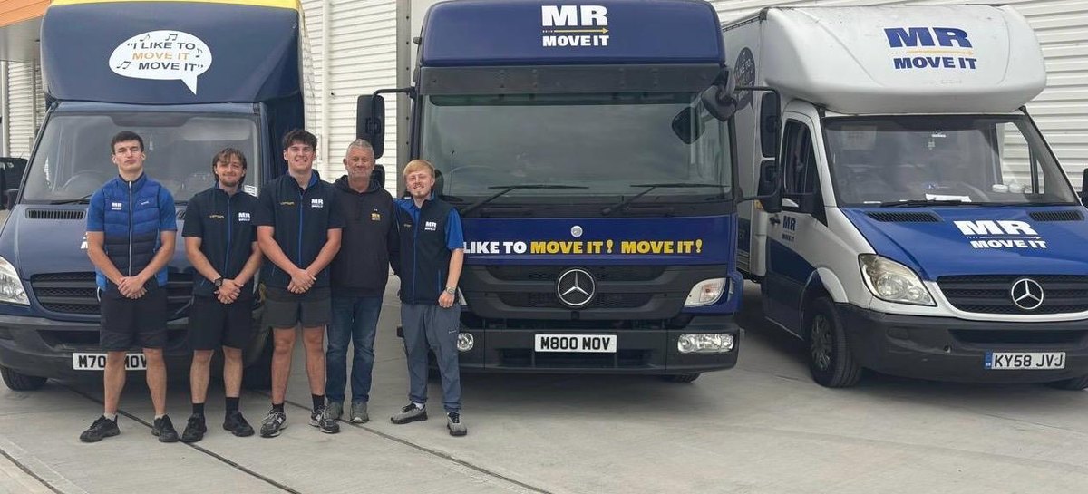 The Mr Move It team with their removals lorry and two liveried vans