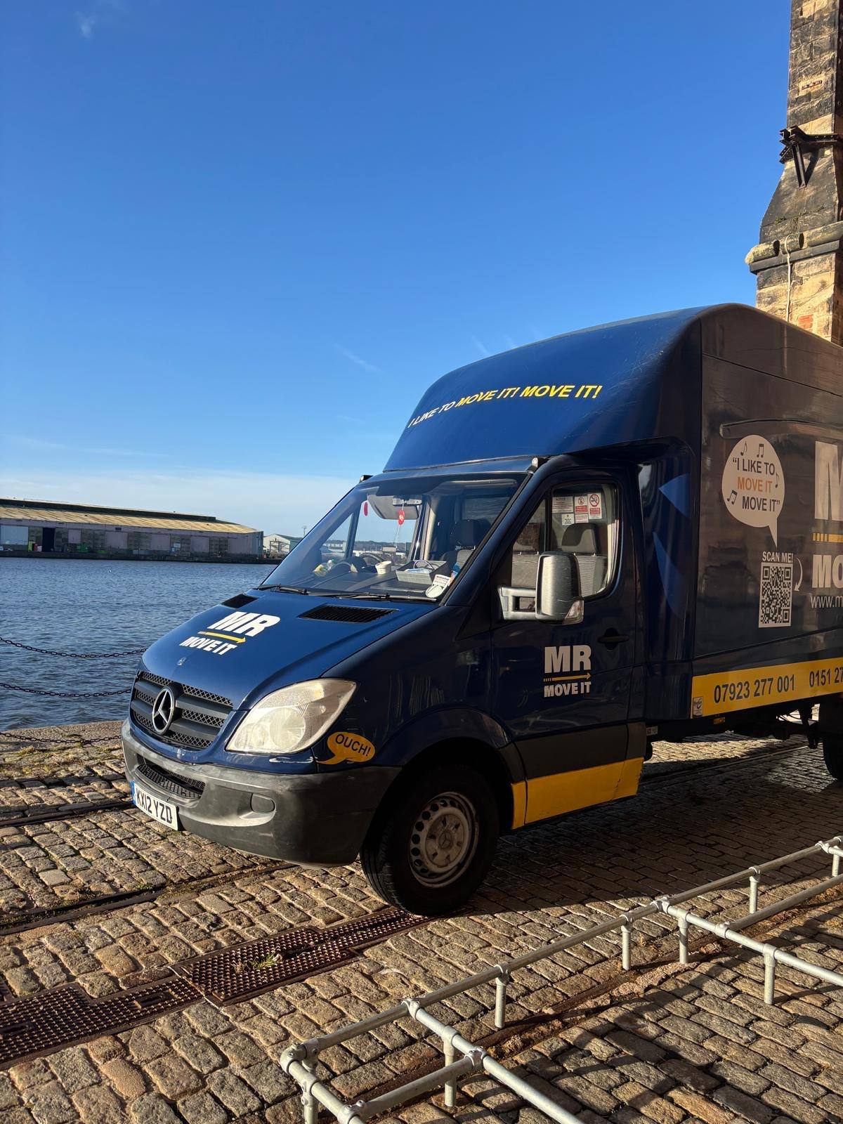 Mr Move It van parked on a waterfront street